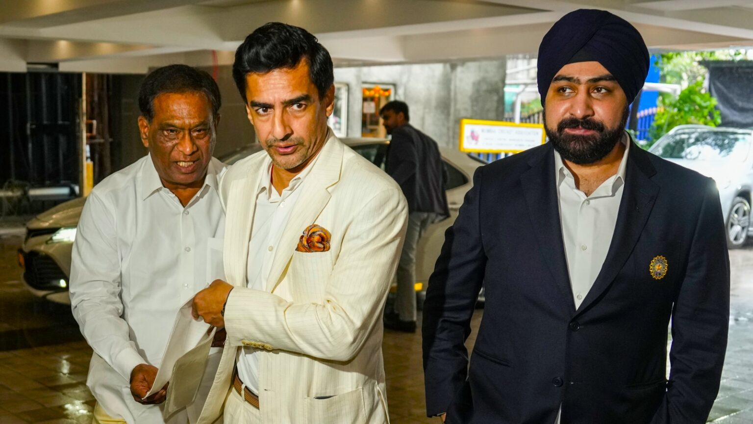 Former cricketer Mithun Manhas, center, and BCCI